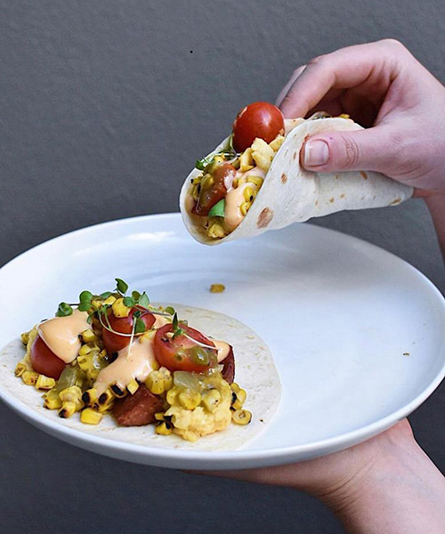 Huevos Rancheros - It has chorizo, scrambled egg, charred corn salsa, green salsa & loco mayo on tortillas